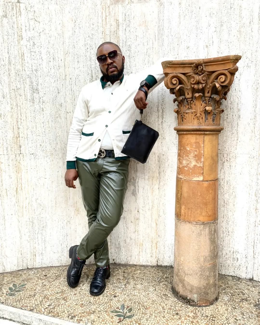 Founder Mkhathini Mlotshwa in a white tailored jacket beside a classical column